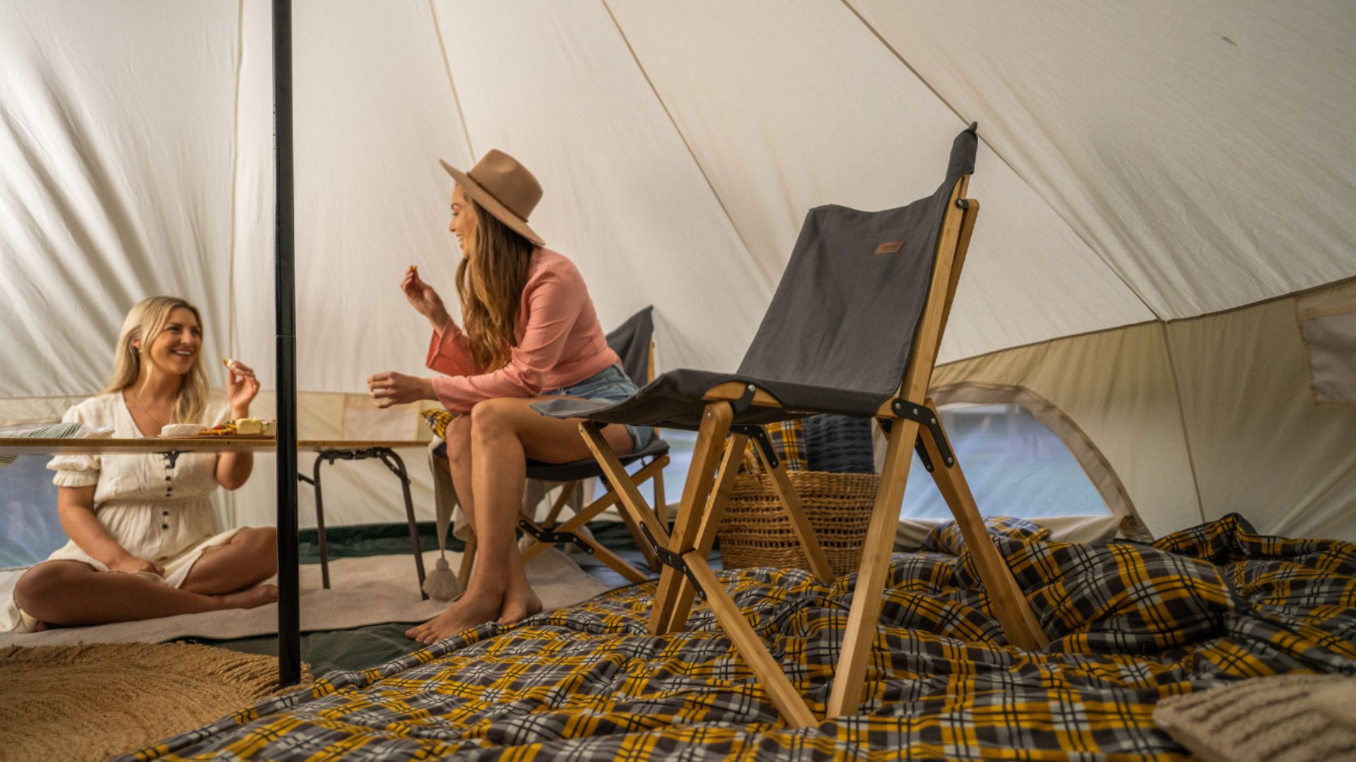 Camping tent set up with chairs, rugs and foldable table