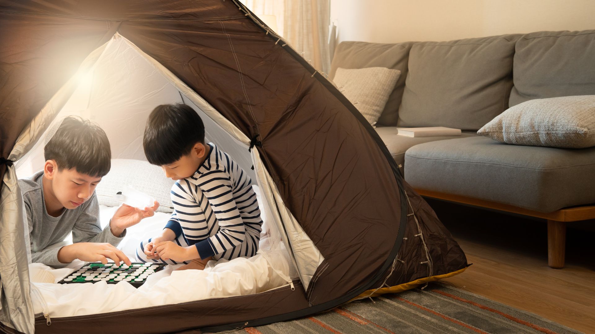 Kids camp at home with an indoor tent set up